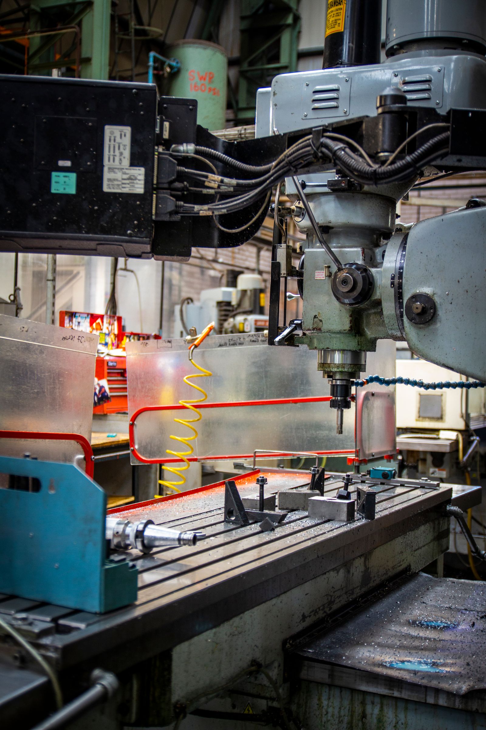 Milling machine on a busy machine shop floor